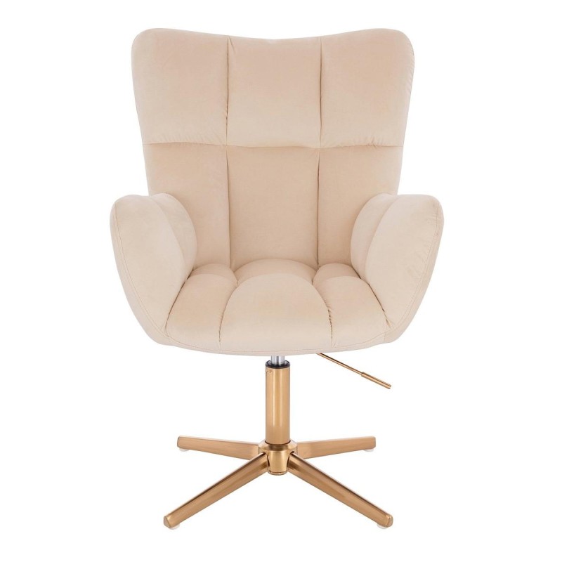 Kremowy welurowy fotel złoty krzyżak