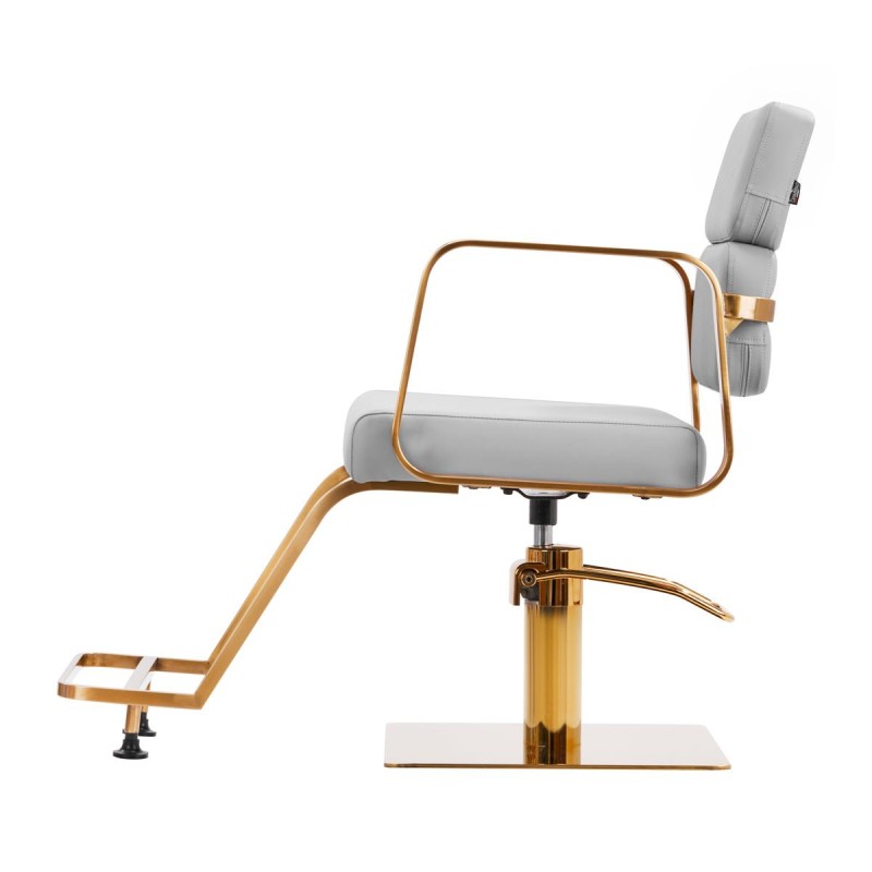 Szary fotel fryzjerski złote akcenty